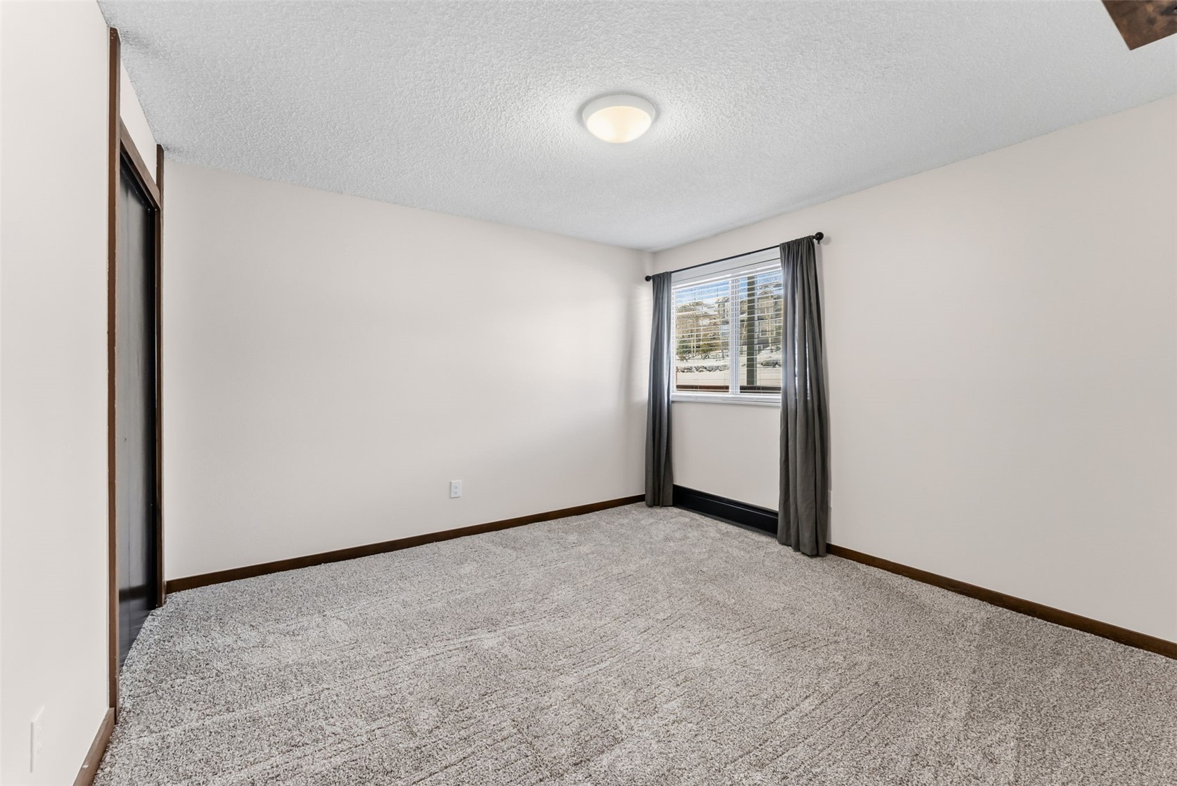 7124 Ryan Gulch Road, Unit 204 Wildernest, CO 80498 - Photo 27 of 36 Empty room with a textured ceiling and carpet