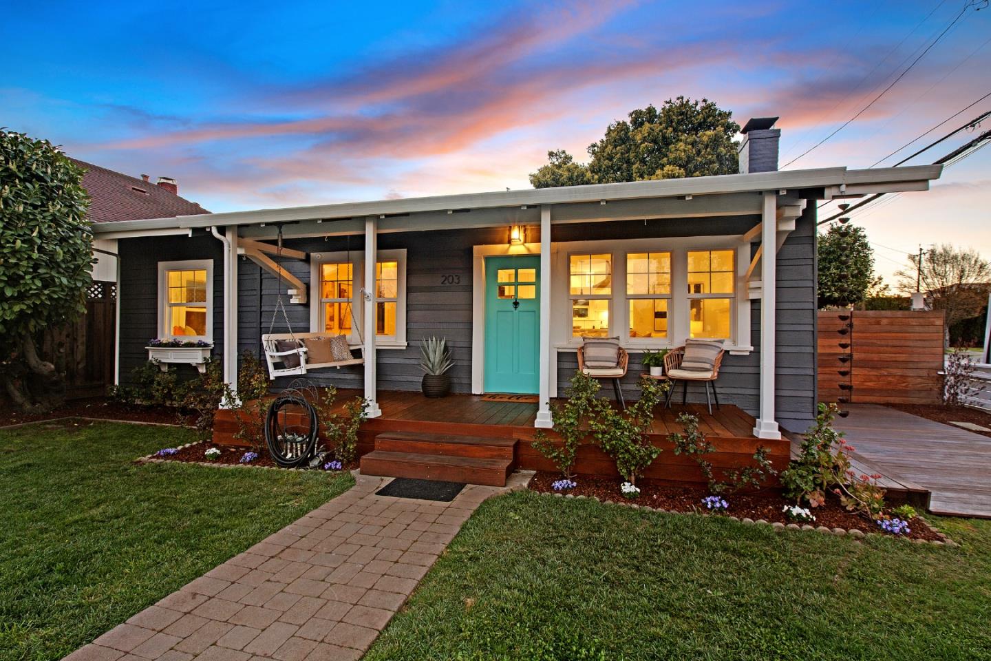 a view of a house with backyard sitting area and garden