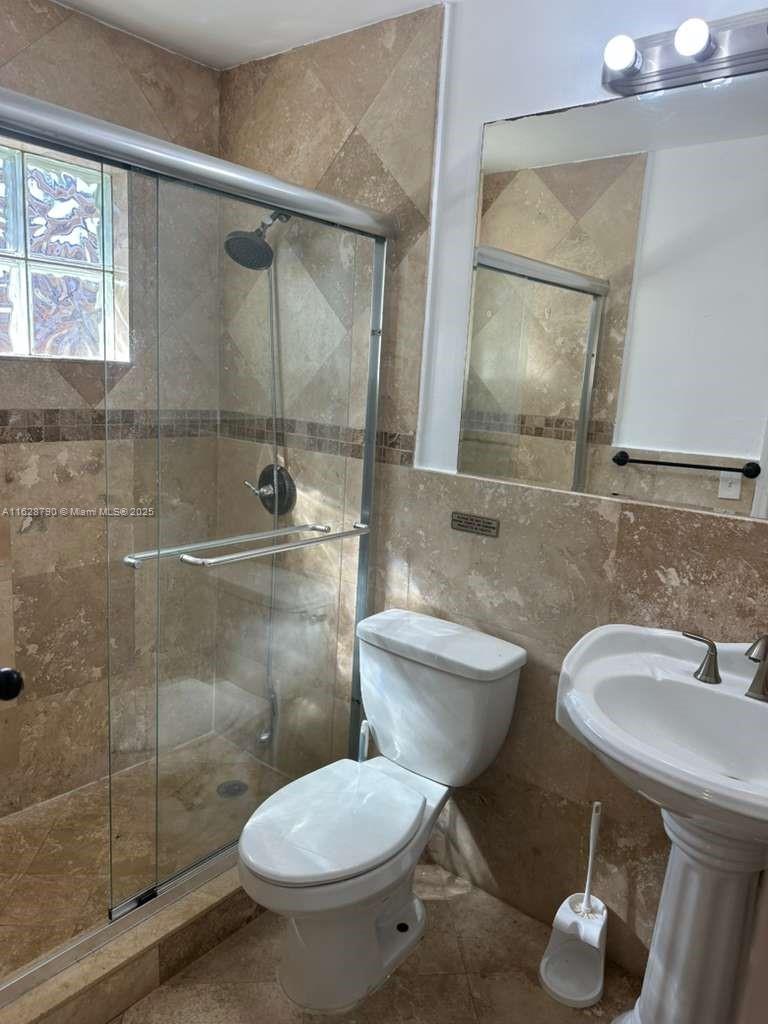 208 Southwest 2nd Avenue Hallandale Beach, FL 33009 - Photo 13 of 21 a bathroom with a toilet sink and shower