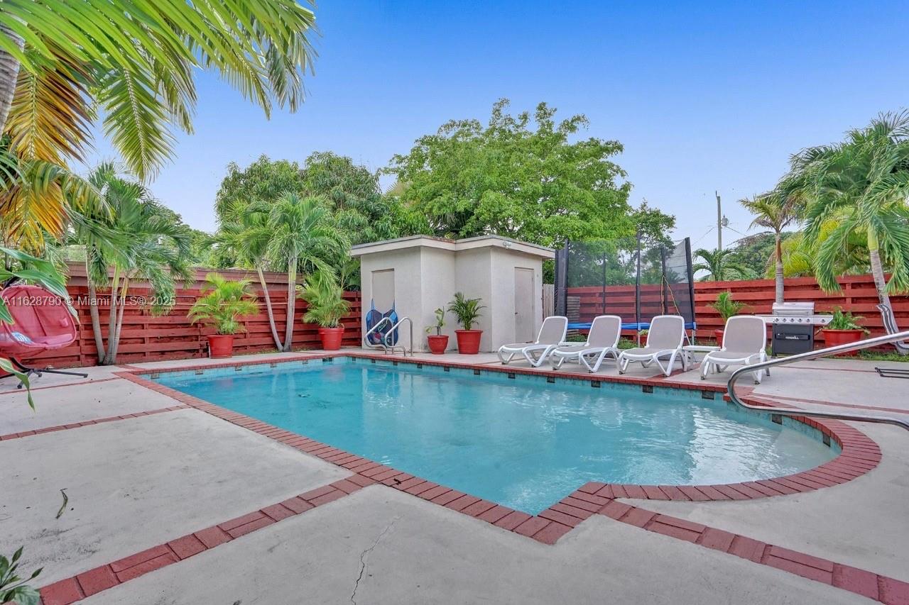208 Southwest 2nd Avenue Hallandale Beach, FL 33009 - Photo 14 of 21 swimming pool view with a seating space and a garden view