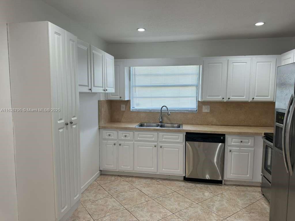 208 Southwest 2nd Avenue Hallandale Beach, FL 33009 - Photo 3 of 21 a kitchen with granite countertop a sink stainless steel appliances and cabinets