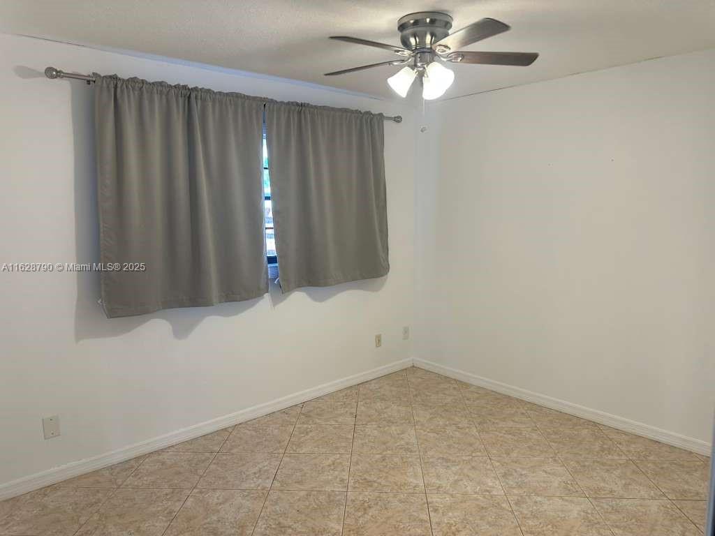208 Southwest 2nd Avenue Hallandale Beach, FL 33009 - Photo 10 of 21 a view of an empty room with chandelier fan