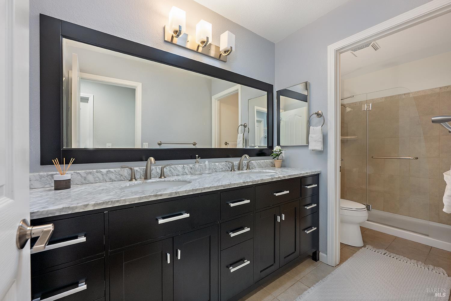 3991 Haven Court Sebastopol, CA 95472 - Photo 24 of 60 a bathroom with a double vanity sink and mirror with toilet