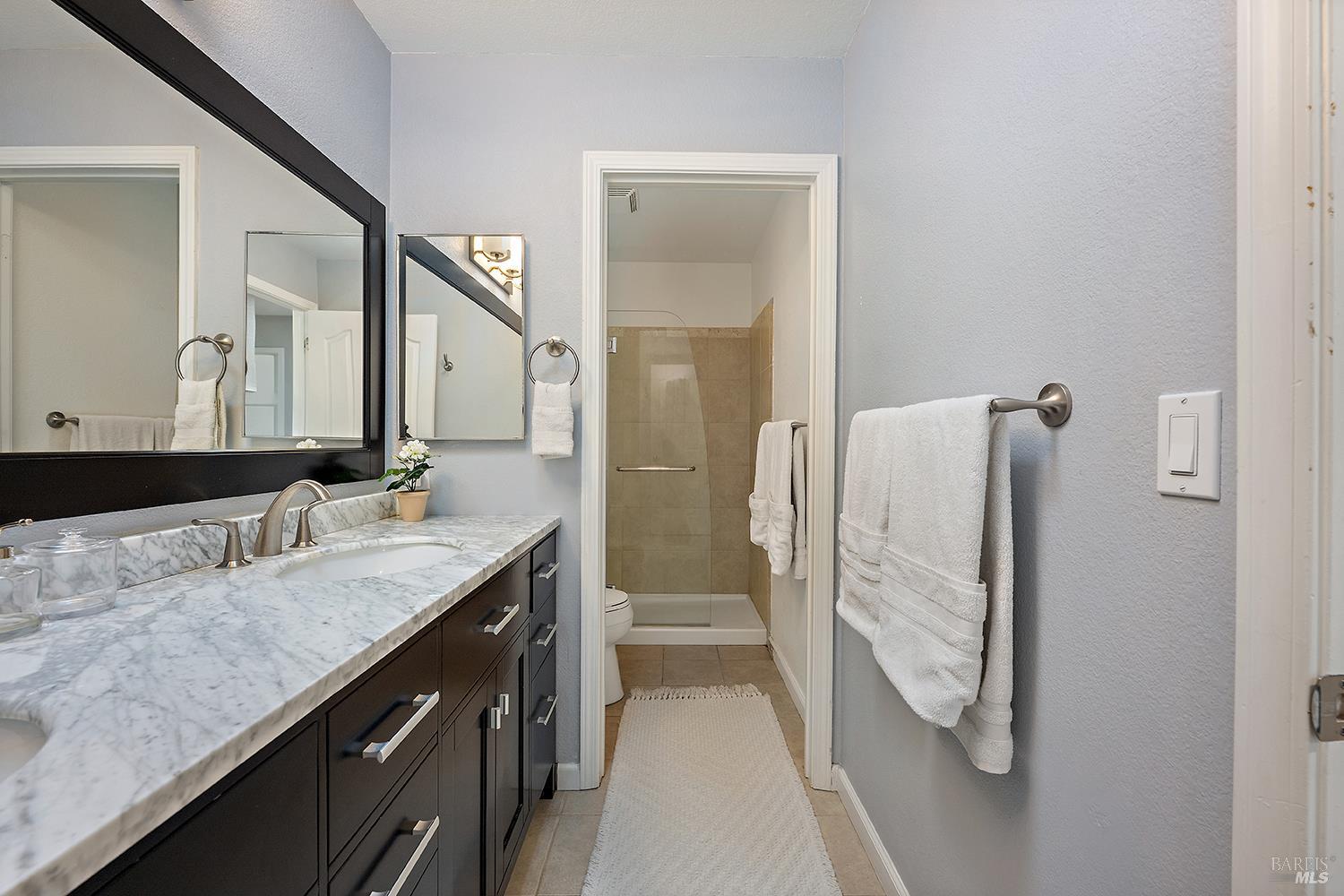 3991 Haven Court Sebastopol, CA 95472 - Photo 25 of 60 a bathroom with a granite countertop sink and a mirror