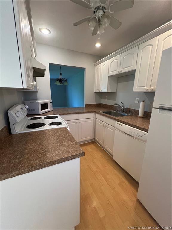 5335 Southeast Miles Grant Road, Unit 214 Stuart, FL 34997 - Photo 3 of 17 a kitchen with granite countertop a sink a stove and cabinets