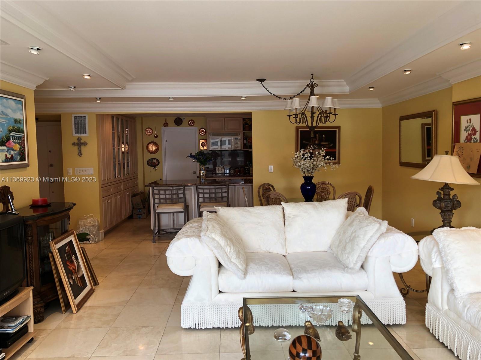 199 Ocean Ln Drive, Unit 705 Key Biscayne, FL 33149 - Photo 3 of 7 a living room with furniture a rug and kitchen view