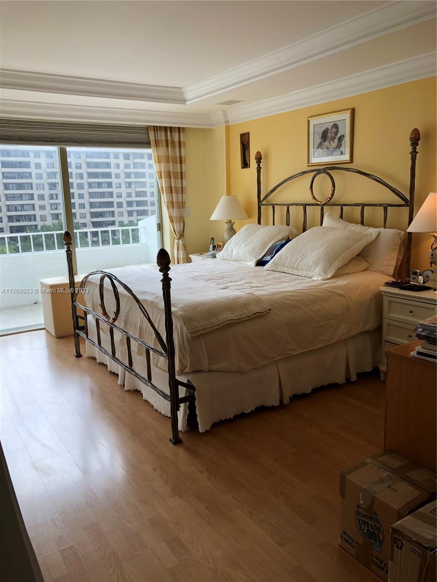 199 Ocean Ln Drive, Unit 705 Key Biscayne, FL 33149 - Photo 6 of 7 a bedroom with a bed and wooden floor