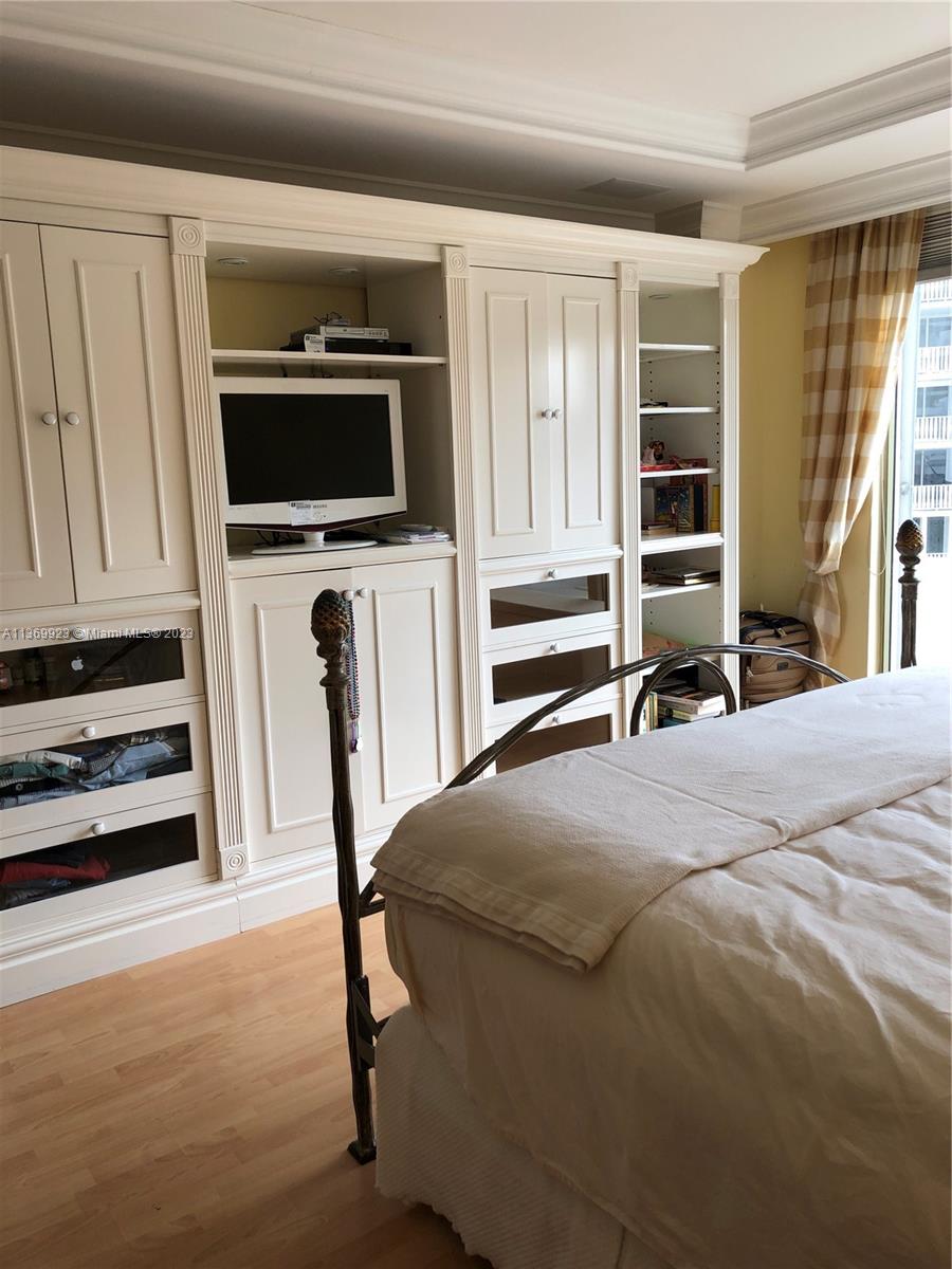 199 Ocean Ln Drive, Unit 705 Key Biscayne, FL 33149 - Photo 7 of 7 a bedroom with a bed and a television in it