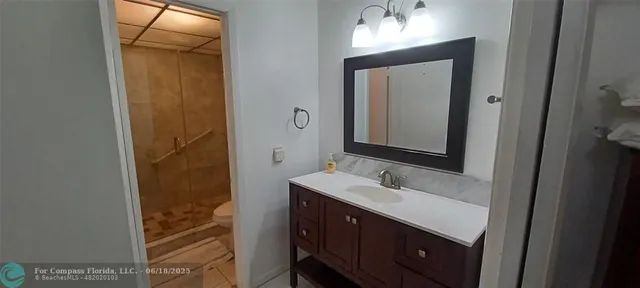 a bathroom with a sink a mirror and a shower