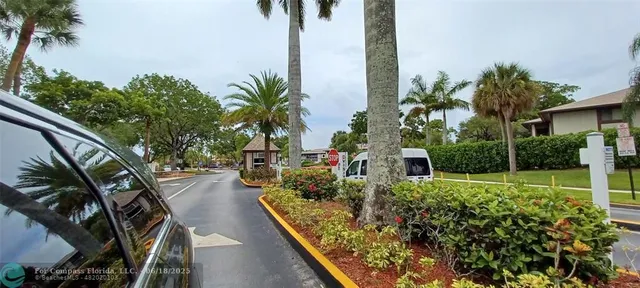 a view of a backyard with potted plants