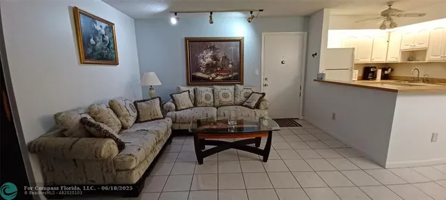a living room with furniture and a painting