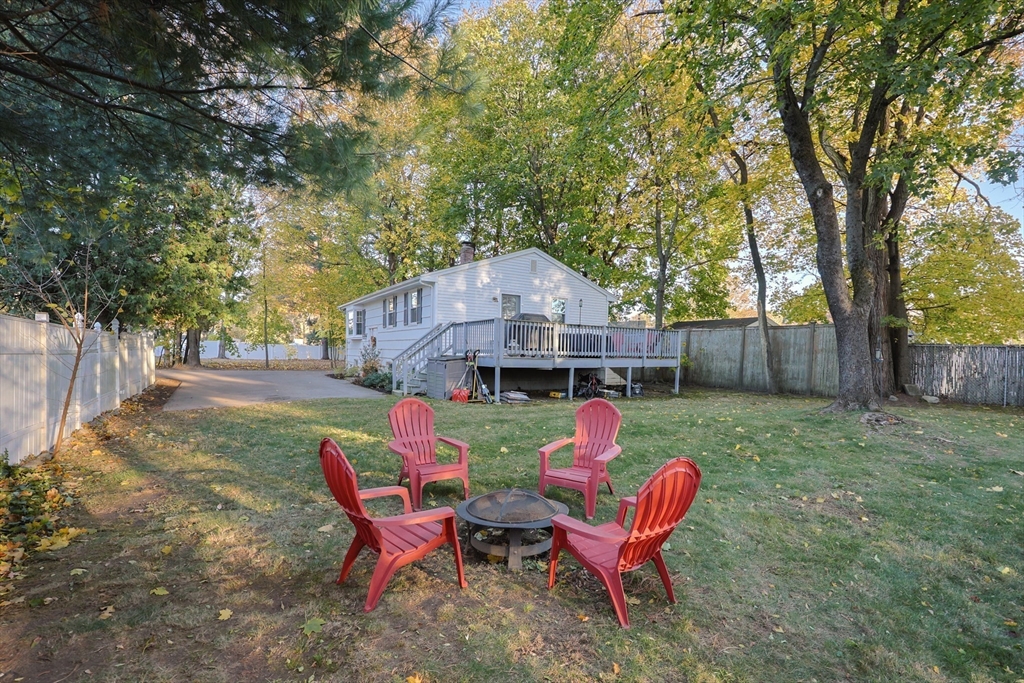 a backyard of a house with table and chairs