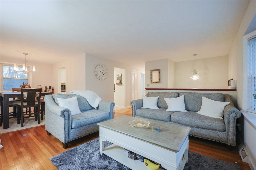 182 Summer Street Framingham, MA 01701 - Photo 12 of 30 a living room with furniture and a dining table with wooden floor