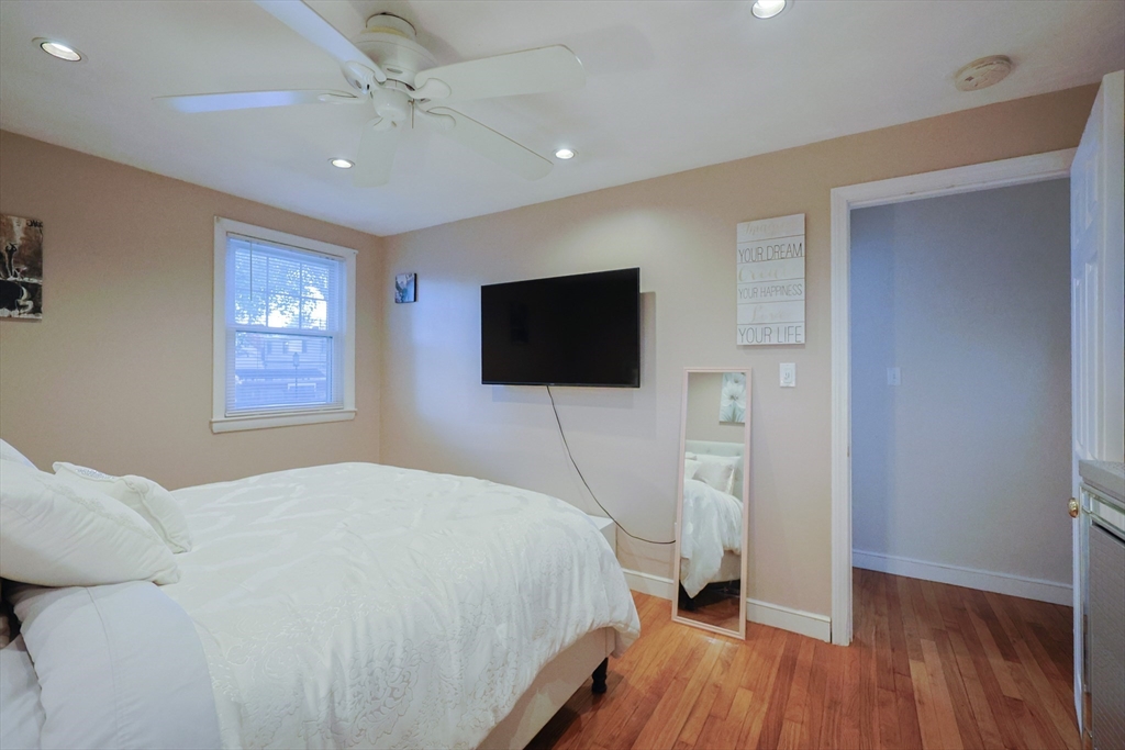 182 Summer Street Framingham, MA 01701 - Photo 16 of 30 a bedroom with a bed and a flat screen tv