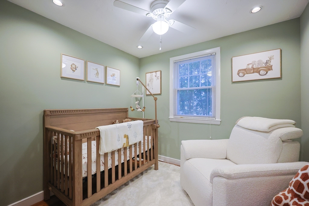 182 Summer Street Framingham, MA 01701 - Photo 18 of 30 a bedroom with a bed and a chandelier