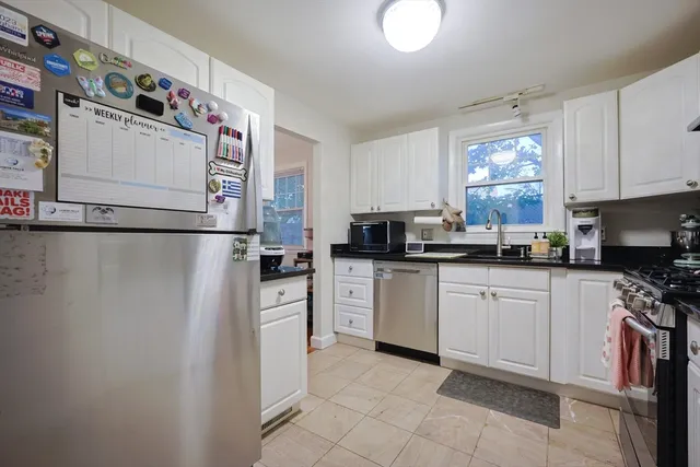 a kitchen with a refrigerator and a stove top oven