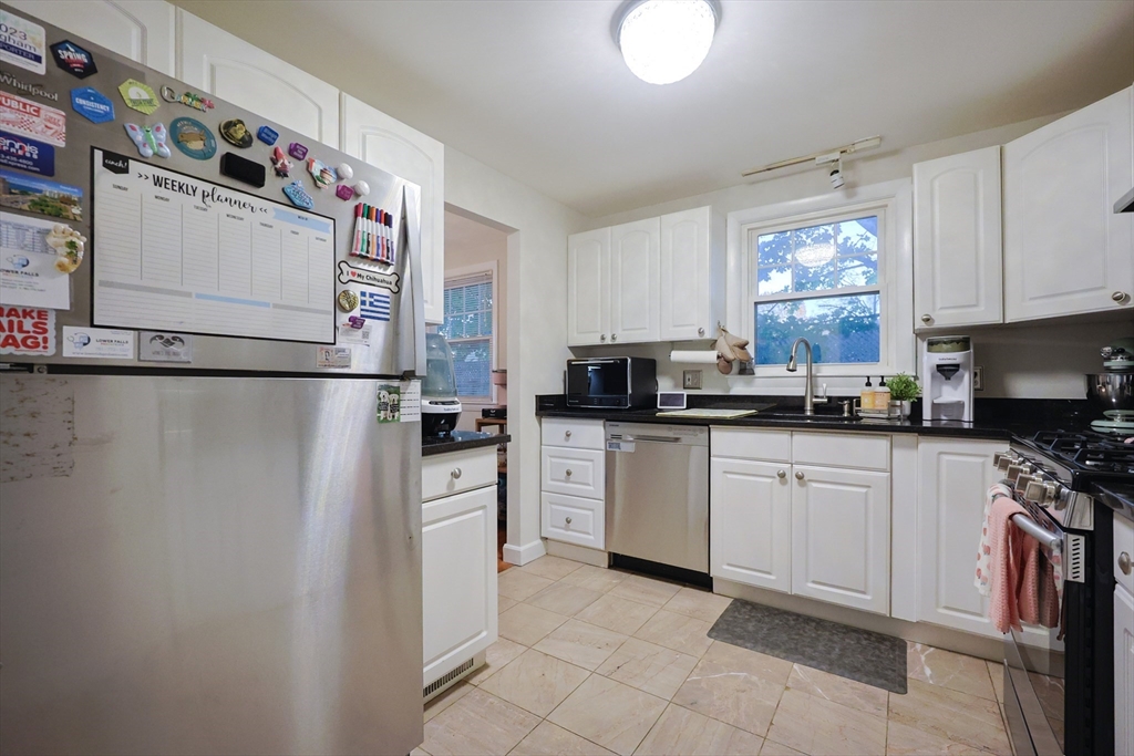 182 Summer Street Framingham, MA 01701 - Photo 7 of 30 a kitchen with a refrigerator and a stove top oven