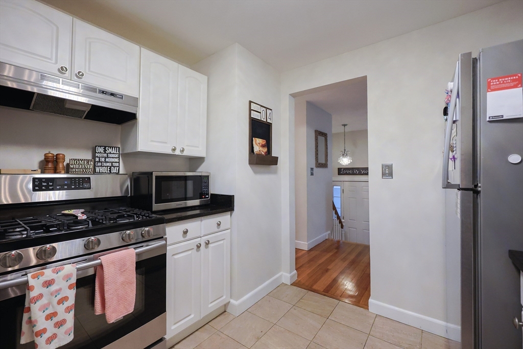 182 Summer Street Framingham, MA 01701 - Photo 8 of 30 a kitchen with granite countertop a sink stove and refrigerator