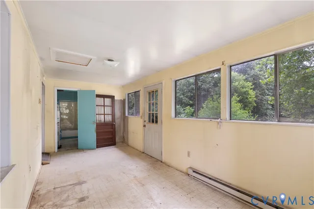 an empty room with windows and closet
