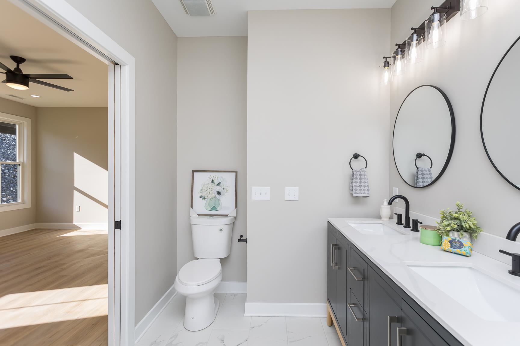 123 Willow Drive Dayton, VA 22821 - Photo 23 of 44 a bathroom with a granite countertop sink a toilet and a mirror
