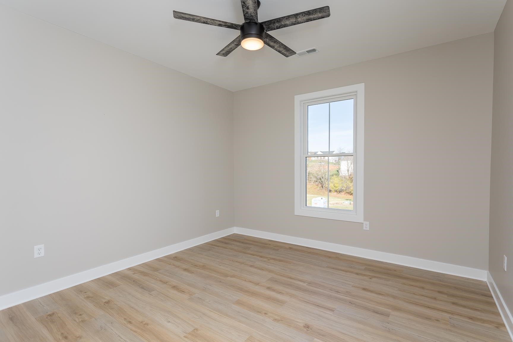 123 Willow Drive Dayton, VA 22821 - Photo 30 of 44 an empty room with wooden floor ceiling fan and windows