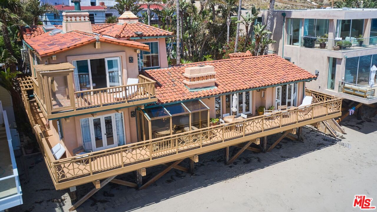 25110 Malibu Road Malibu, CA 90265 - Photo 1 of 28 a view of a house with a wooden deck and a chair