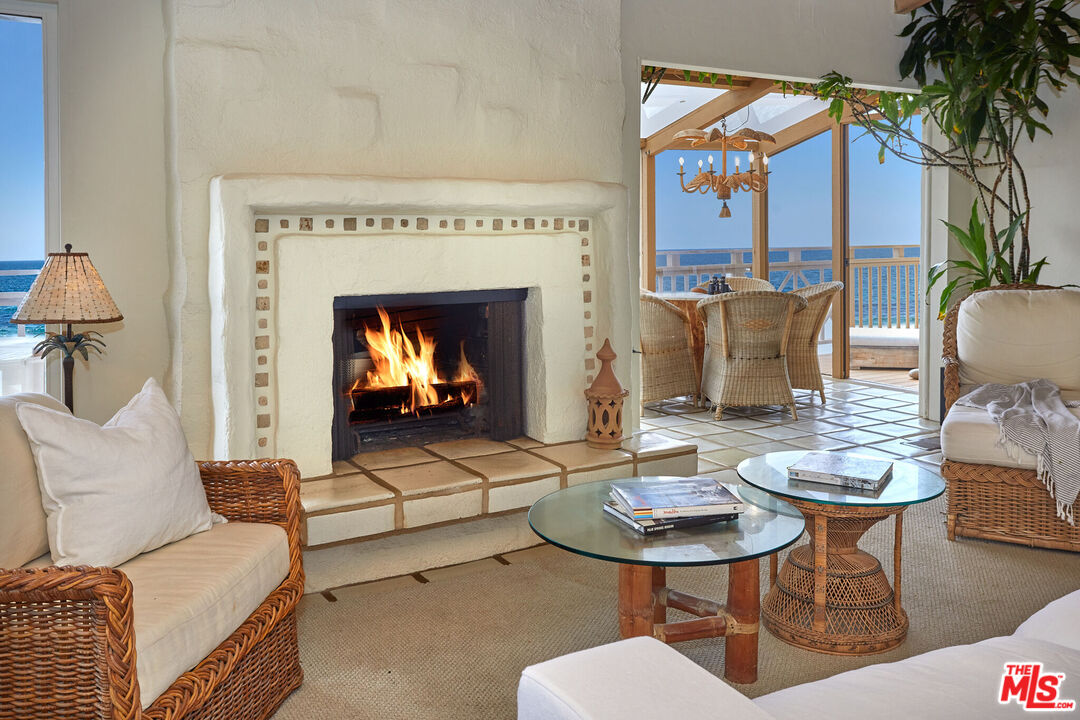 25110 Malibu Road Malibu, CA 90265 - Photo 11 of 28 a living room with furniture a table and a fireplace