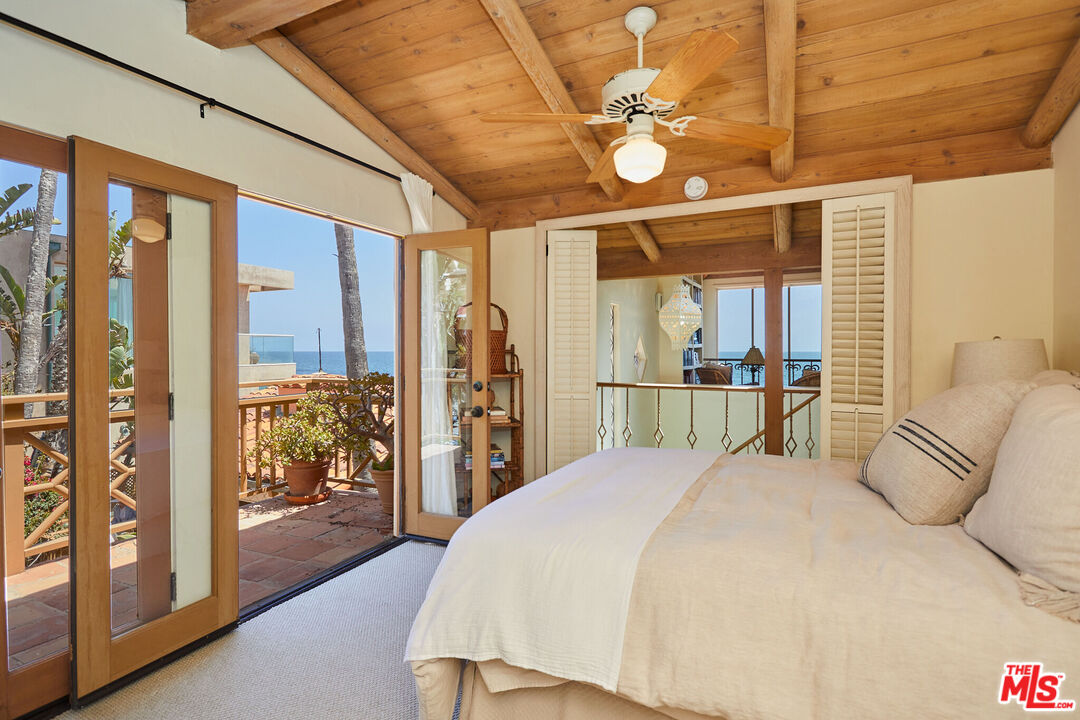 25110 Malibu Road Malibu, CA 90265 - Photo 14 of 28 a bedroom with a large bed and a large window with the outer view