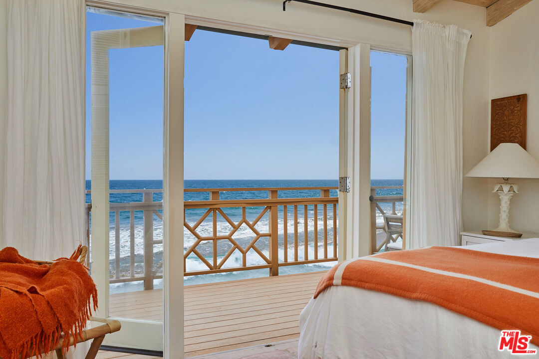 25110 Malibu Road Malibu, CA 90265 - Photo 10 of 28 a bedroom with a bed and a window