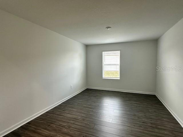 4534 Southwest 84th St Road Ocala, FL 34476 - Photo 12 of 31 an empty room with wooden floor and windows