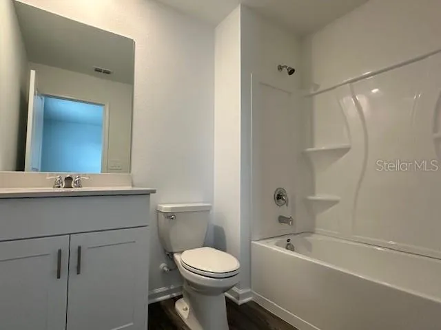 an empty room with a ceiling fan and bathroom