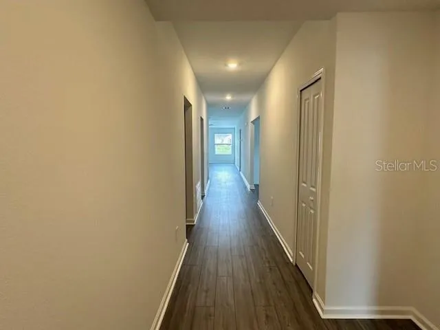 a view of a hallway with wooden floor