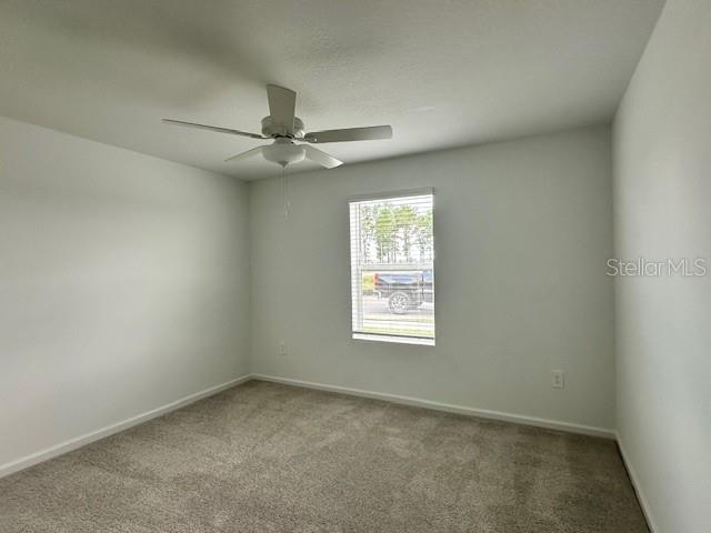 4534 Southwest 84th St Road Ocala, FL 34476 - Photo 7 of 31 an empty room with a window and a fan