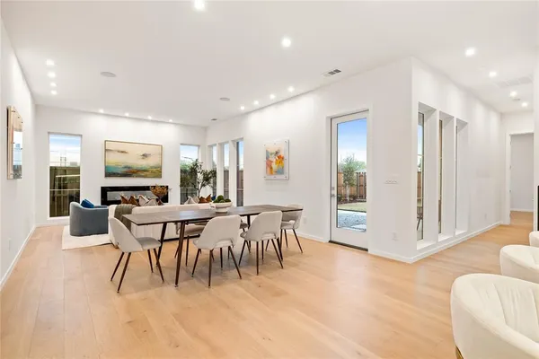 a dining room with furniture and wooden floor