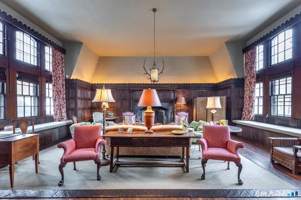 a room with furniture a rug and a chandelier