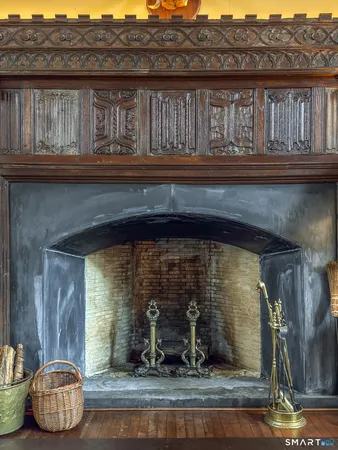 a room with fireplace and mirror