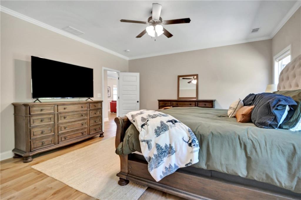 90 Scouts Ridge Drive Covington, GA 30016 - Photo 12 of 21 a bedroom with a bed and a flat tv screen on dresser