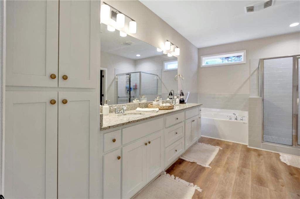 90 Scouts Ridge Drive Covington, GA 30016 - Photo 13 of 21 a spacious bathroom with a double vanity sink a mirror and a shower
