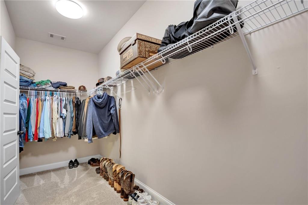 90 Scouts Ridge Drive Covington, GA 30016 - Photo 14 of 21 a view of walk in closet with clothes and shoes