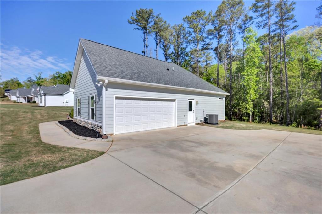 90 Scouts Ridge Drive Covington, GA 30016 - Photo 21 of 21 a view of a house with a yard and garage