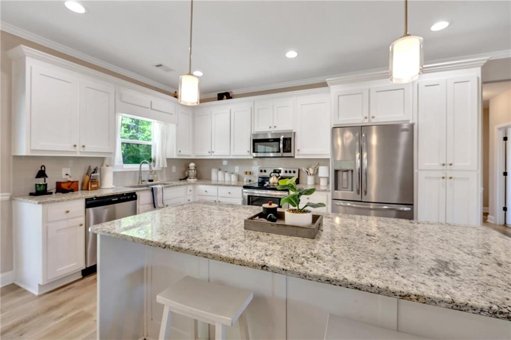 90 Scouts Ridge Drive Covington, GA 30016 - Photo 10 of 21 a kitchen with refrigerator a sink and chairs