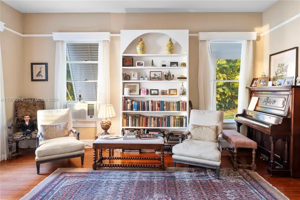a living room with furniture and wooden floor