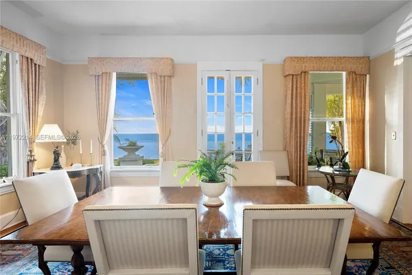 a view of a house with a yard and a large tree