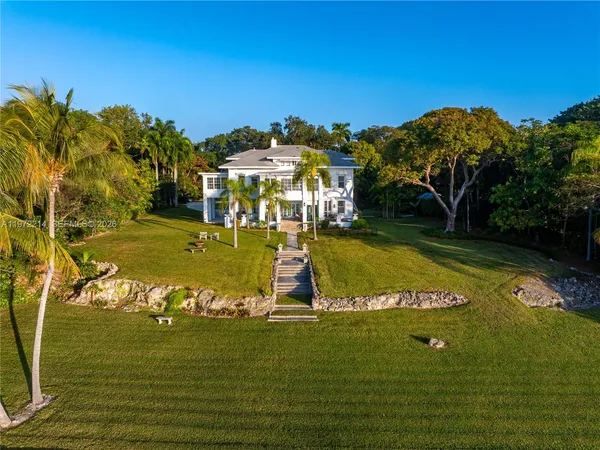 a view of a balcony with two chairs and a potted plant