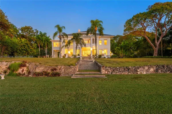 a view of an ocean with a table and chairs