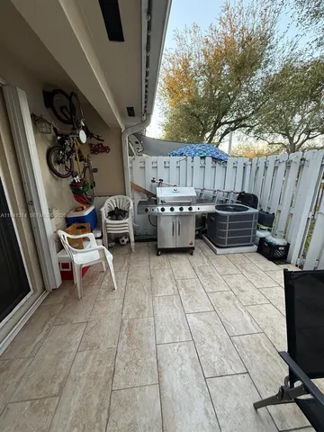 a view of a chairs and tables in patio