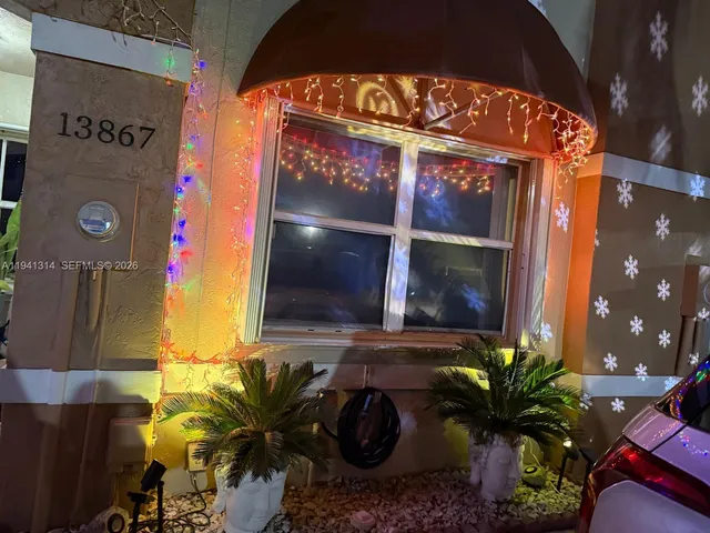 a white bench sitting in front of a window