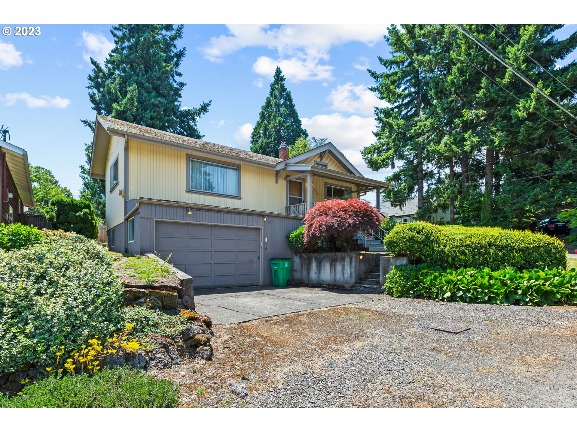 a front view of house with yard and trees around