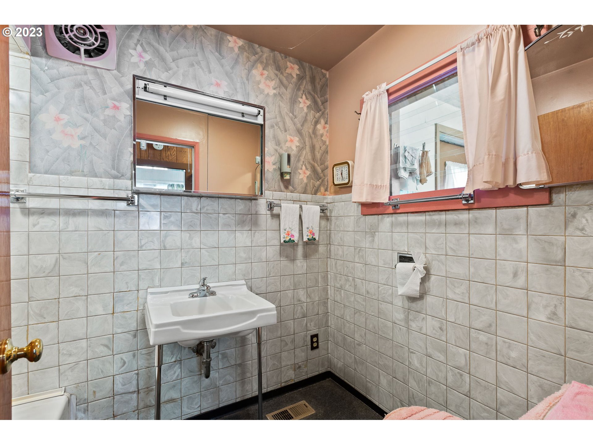 3554 Southwest Falcon Street Portland, OR 97219 - Photo 17 of 23 a bathroom with a sink a mirror and a shower
