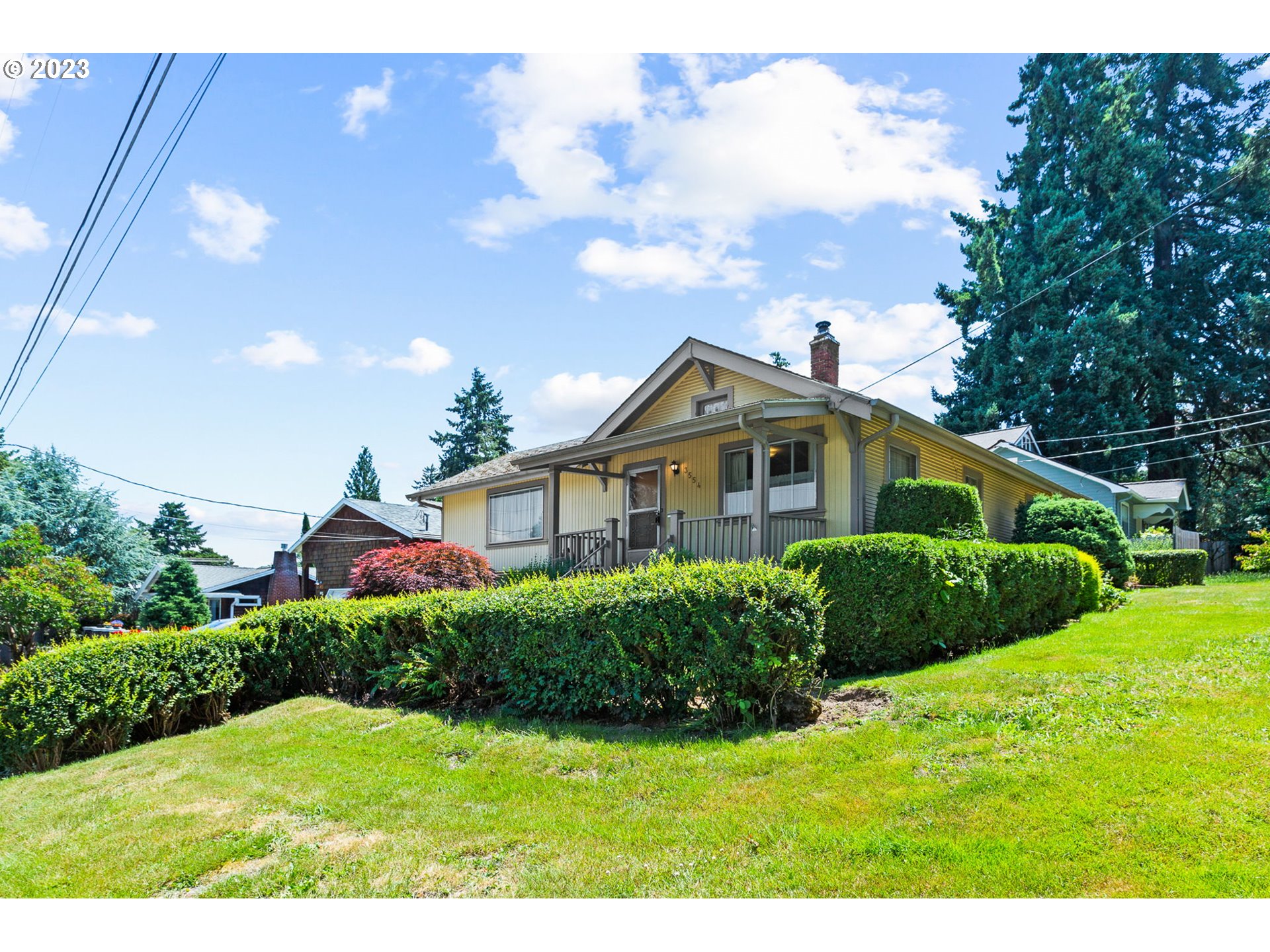 3554 Southwest Falcon Street Portland, OR 97219 - Photo 2 of 23 a front view of a house with a yard